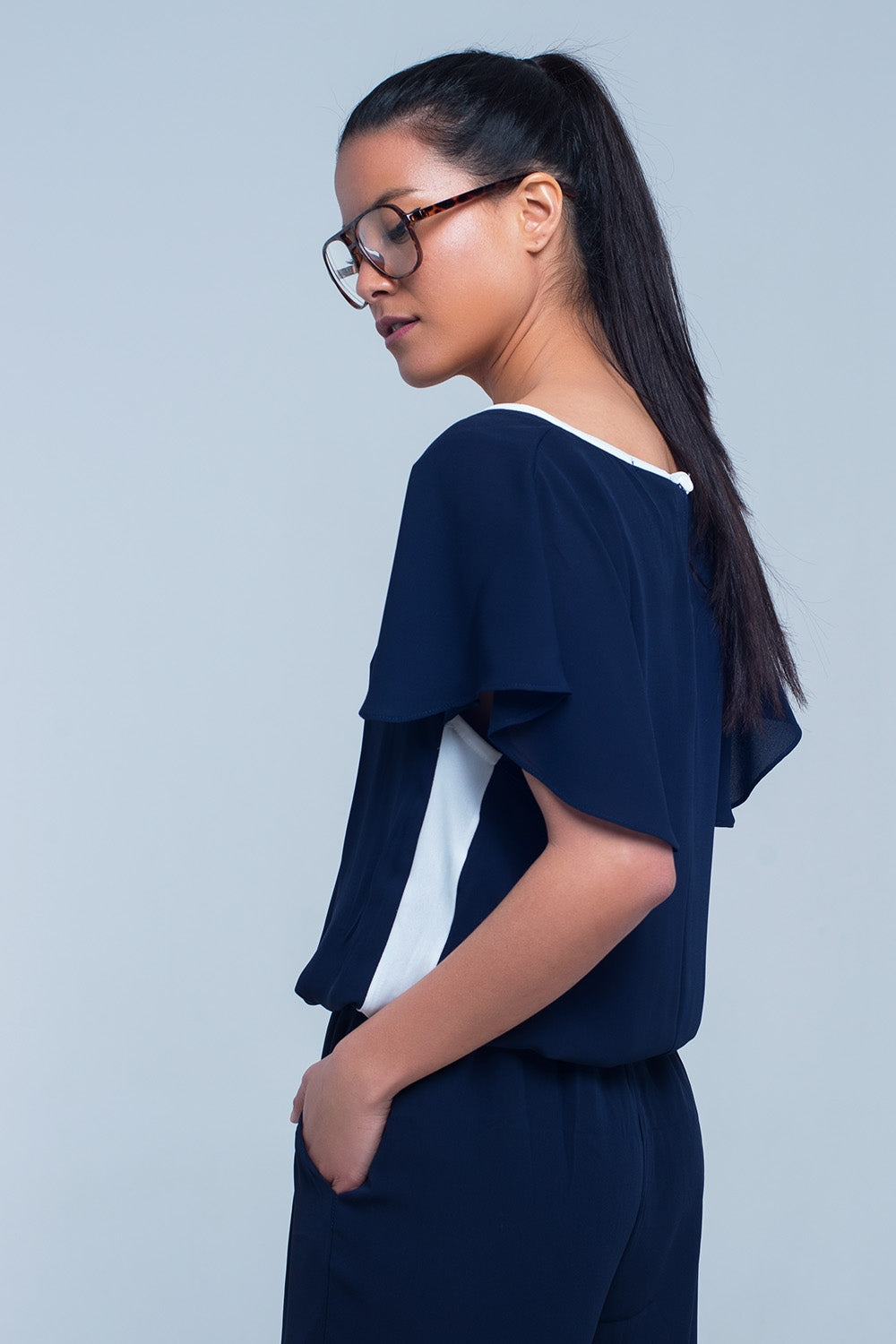 Navy blue jumpsuit with short sleeve and ruffle detail