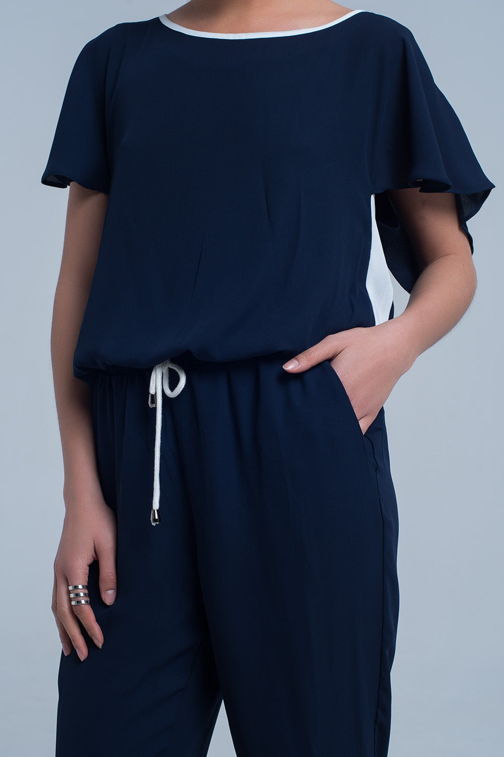 Navy blue jumpsuit with short sleeve and ruffle detail