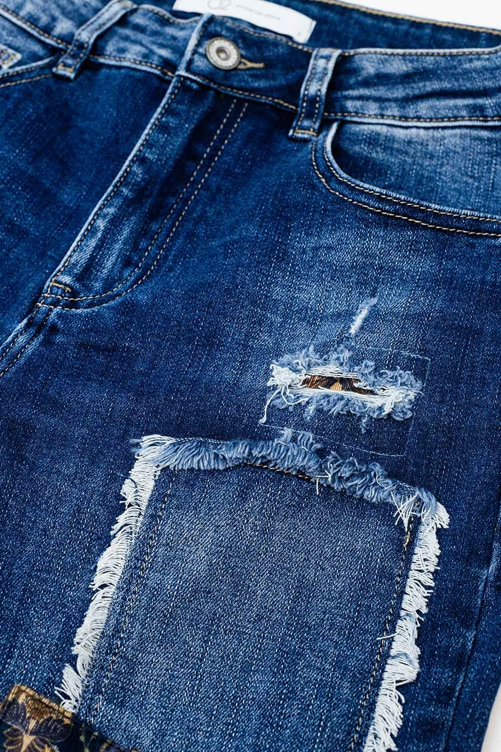 Loose blue jeans with subtle ripped design and patches