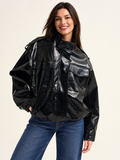 Shiny faux leather oversized Jacket in black on an adult model; accessories and other clothing are styling only.